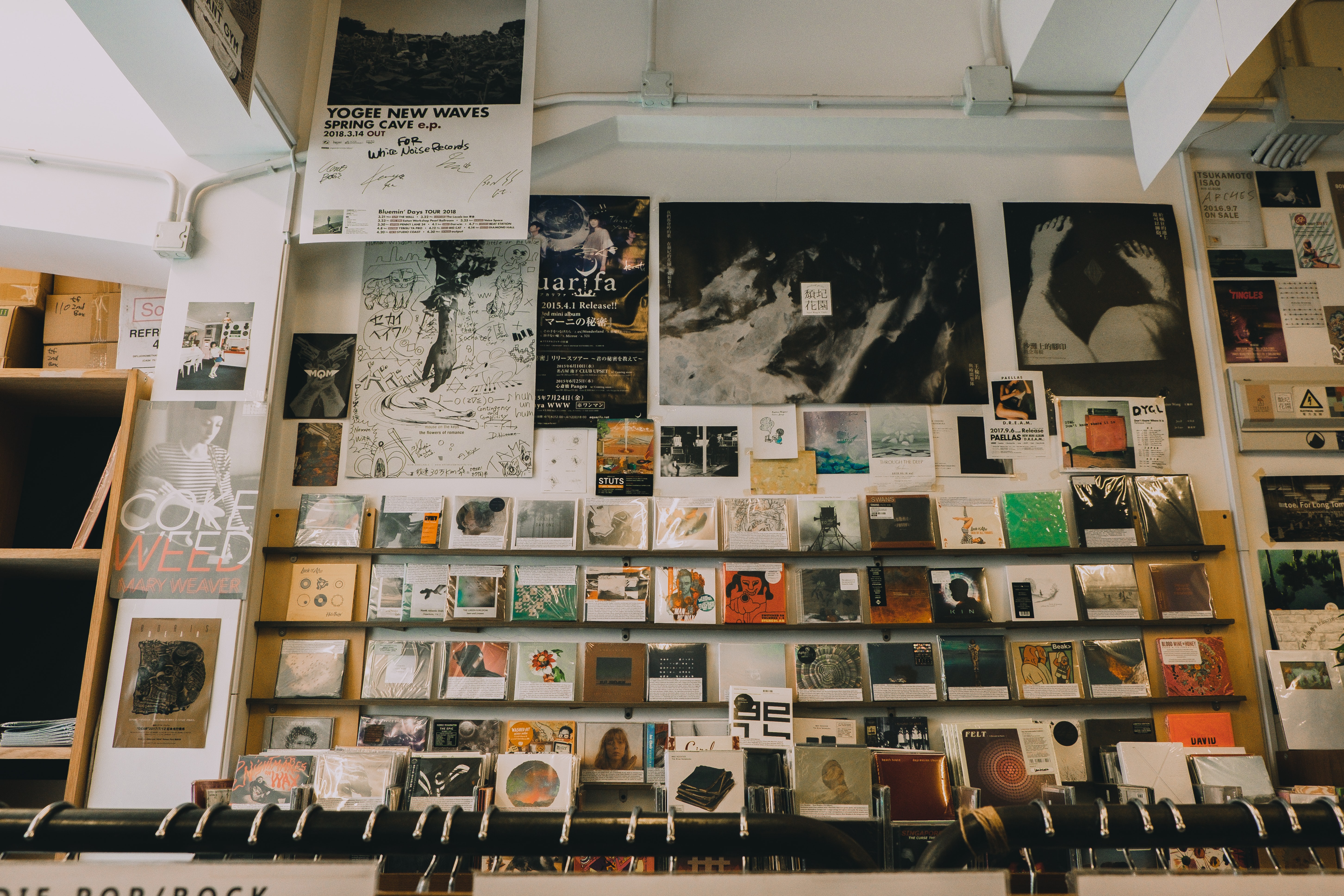 Low angle shot of CDs and music posters in a music shop.